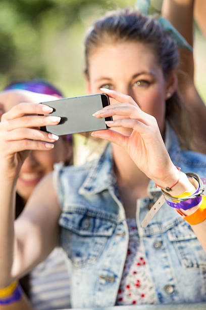 istock Excited music fan taking photo 472915604