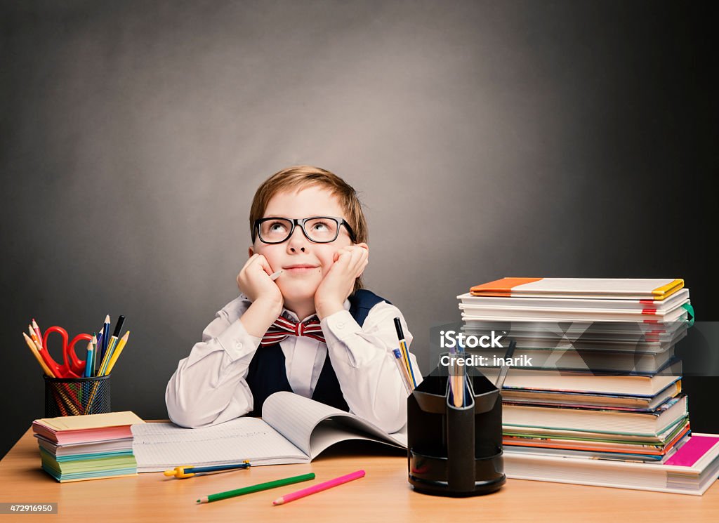 School Child Boy in Glasses Think, Kid Students Reading Books School Child Boy in Glasses Think in Classroom, Kid Primary Students Reading Book, Pupil Learn Lesson and Dream, Education Concept 2015 Stock Photo