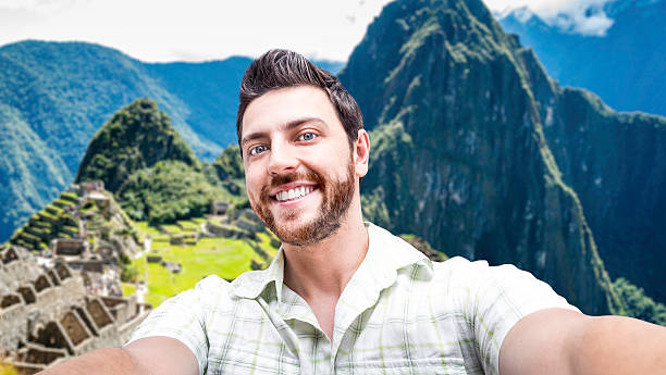 istock Happy young man taking a selfie photo in Peru 472917238
