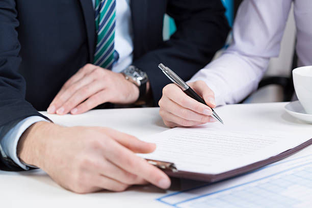 istock Female hands signing contract 472920158