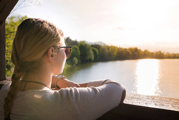 istock Woman Looking Sunset at Lake 472920176