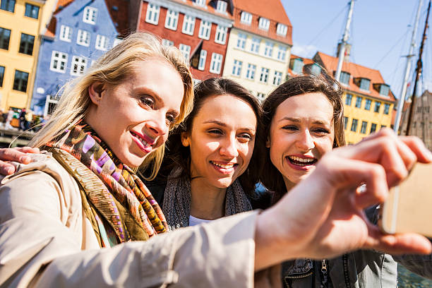 istock Friends on travel taking a selfie on mobile 472923860