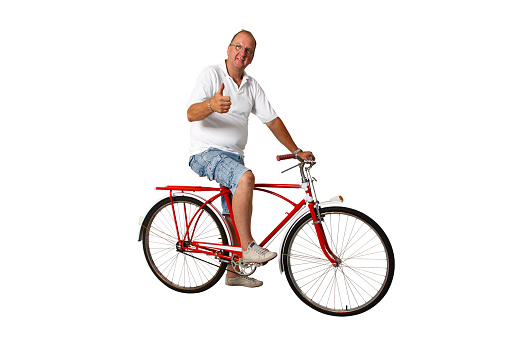 Brazilian man riding an antique bike with thumbs up on an isolated white background