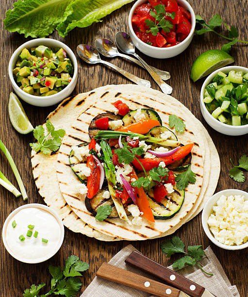 Vegetarian snack tacos with grilled vegetables and salsa.