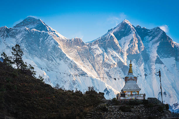 Traditional white-washed stupa on the Everest Base Camp trail high in the Khumbu valley overlooked by Mt. Everest (8848m) Lhotse (8412m) and Nuptse (7861m) deep in the remote Himalayan wilderness of the Sagarmatha National Park, a UNESCO World Heritage Site, Nepal. ProPhoto RGB profile for maximum color fidelity and gamut.
