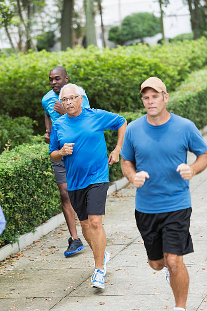 istock Multiracial group of men running in the park 472927082