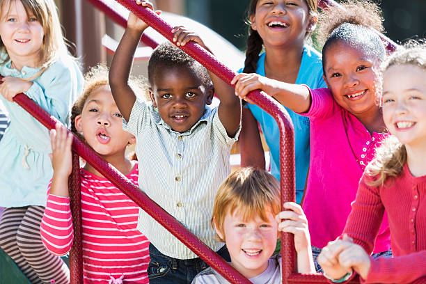 istock Big group of multi-ethnic children on a sunny playground 472927102