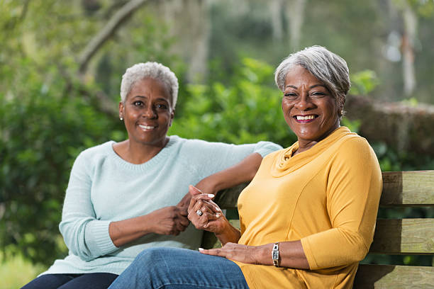 istock Two senior women sitting on park bench 472927130