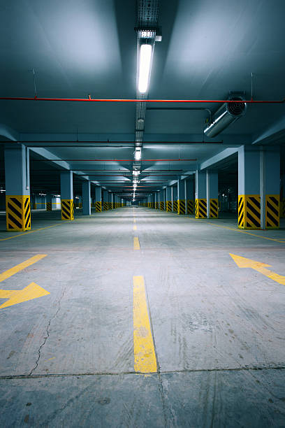 First floor of cold, dark parking garage stock photo