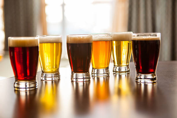 istock Six samples of beer on a table in the pub. 472933912