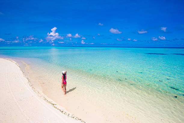 istock Young beautiful woman relaxing at white sand tropical beach 472936990