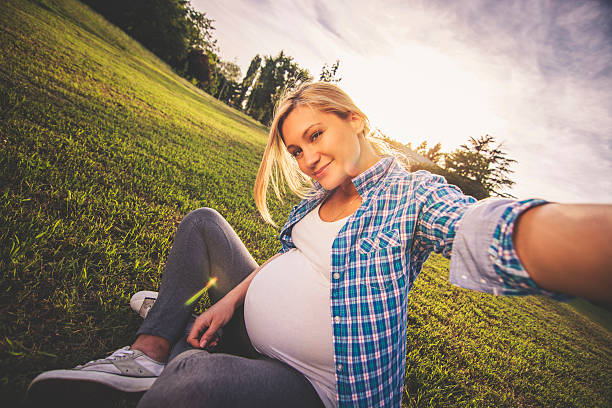 Pregnant woman taking selfie