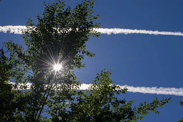 An image of aerosol trails sprayed by an airplane.