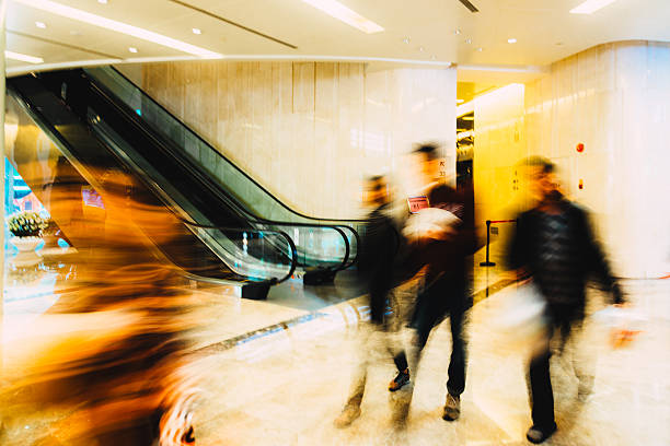 istock Business concept shoppers walking in a mall 472939268