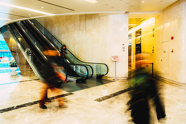 istock Business concept shoppers walking in a mall 472939316