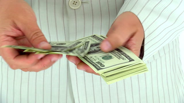 Businessmen counting money hundred dollar bills