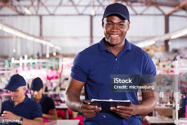 African American Textile Worker Holding A Clipcoad Stock Photo - Download Image Now - Uniform, Men, Occupation