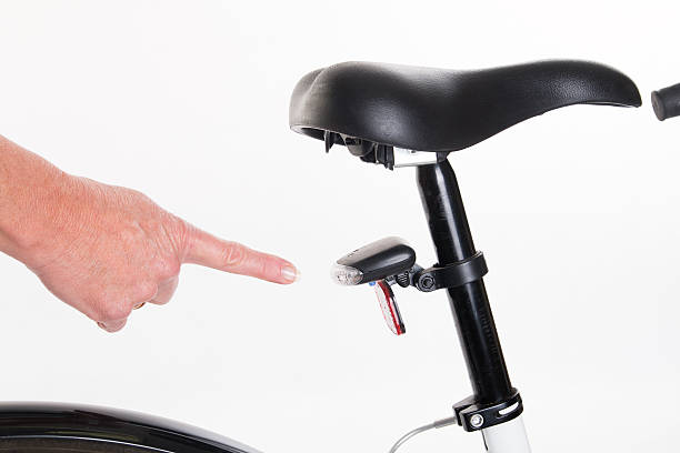 istock Hand pointing at the rear bike light 472942506