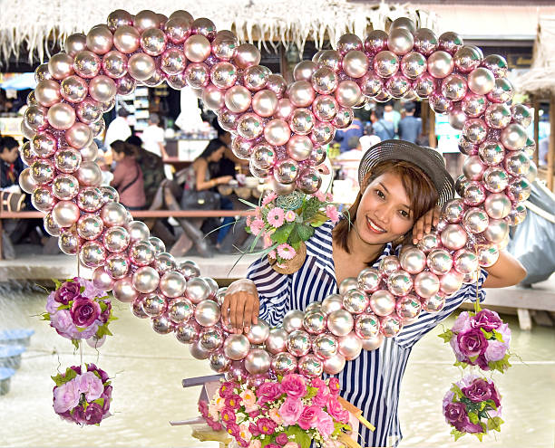 Beautiful girl inside the heart at Bangnamphueng floating market