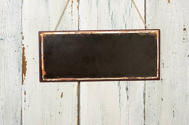 istock Empty metal sign in front of a white wooden wall 472942852