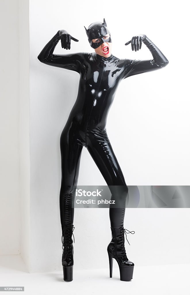 standing woman standing woman wearing latex clothes Latex Stock Photo