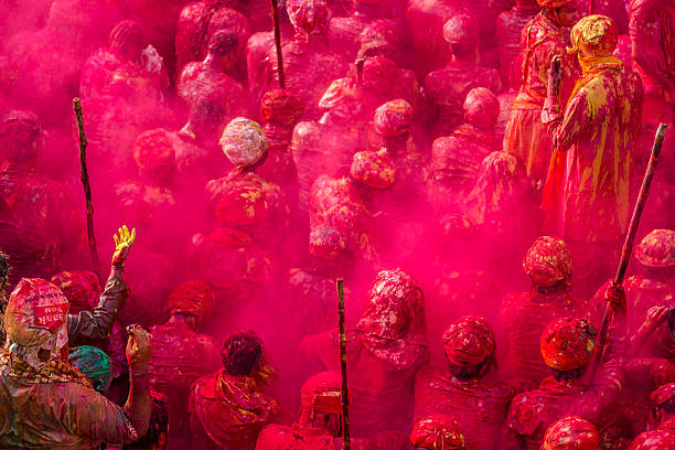 Holi celebration in Nandgaon, India Nandgaon, India - March 10, 2014: Nandgaon, India - March 10, 2014 : Villagers celebrate Holi by throwing colors to each other at Krishna temple in Nandgaon. singh stock pictures, royalty-free photos & images