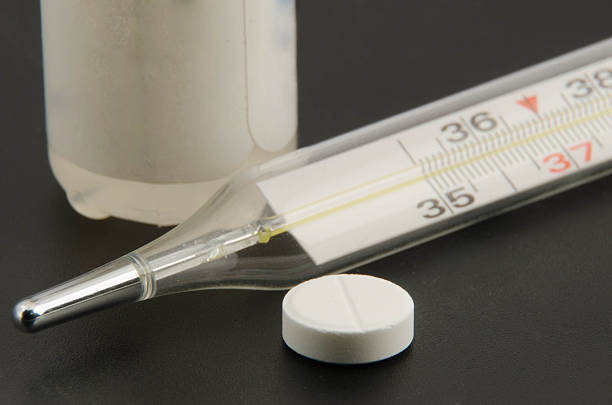istock Glass mercury thermometer isolated over white background. 472954586