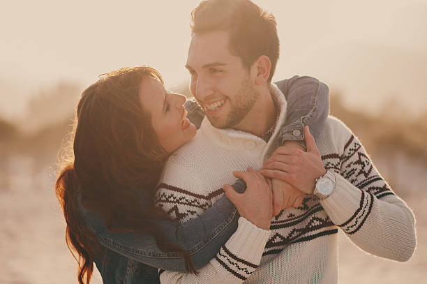 istock Lovely young couple on the sunset beach 472957598