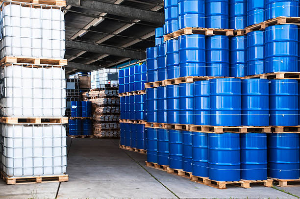 Blue drums and container Blue drums and IBC container in a storage room drum container stock pictures, royalty-free photos & images