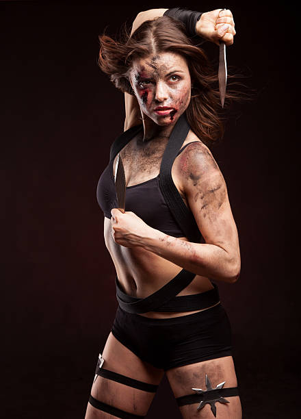 istock Killer woman with knife. Posing in studio. 472963250