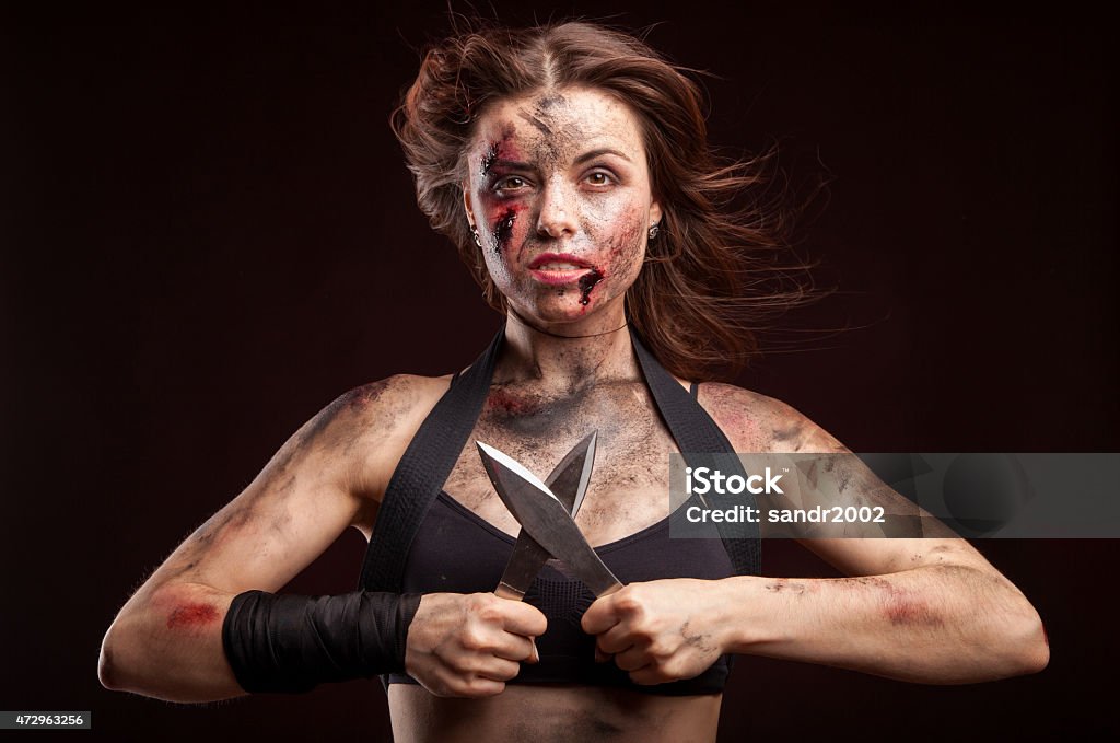 Killer woman with knife. Posing in studio. Assassination Stock Photo