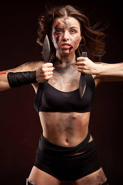istock Killer woman with knife. Posing in studio. 472963258