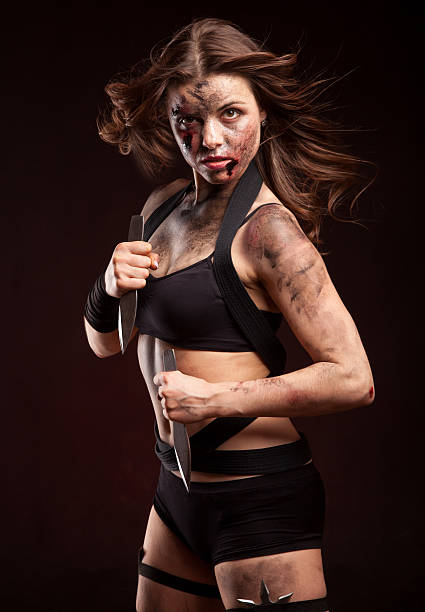 istock Killer woman with knife. Posing in studio. 472964104