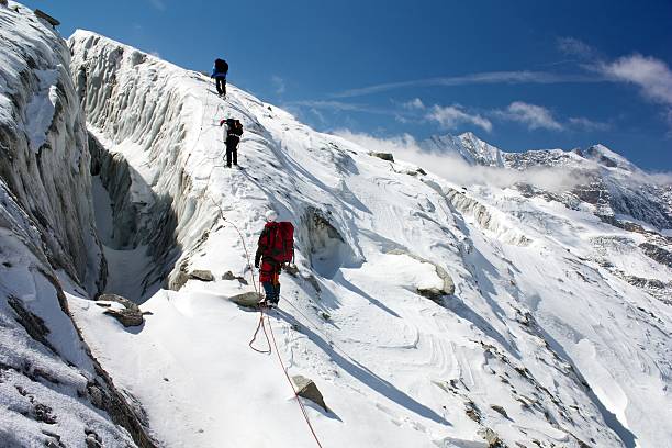 group of climbers on rope on glacier stock photo