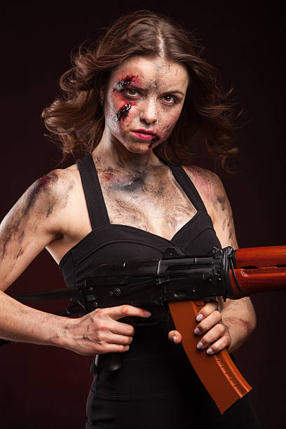 istock Beautiful sexy girl with gun. Posing in studio. 472967012
