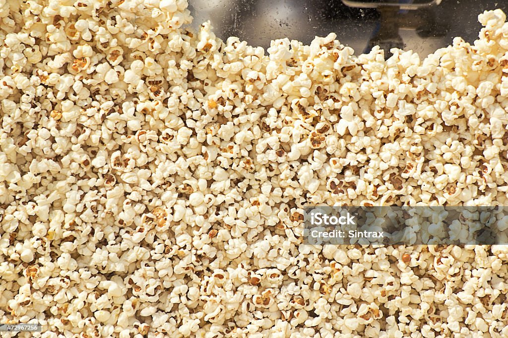 Fresh popcorn texture Fresh hot popcorn just popped by a popping machine. Front view. Popcorn Maker Stock Photo