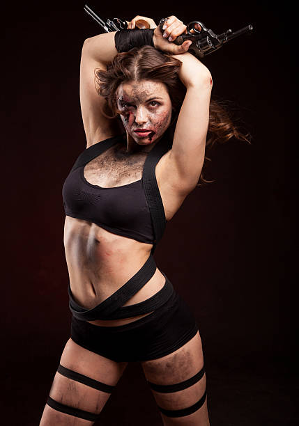 istock Killer woman with knife. Posing in studio. 472971054