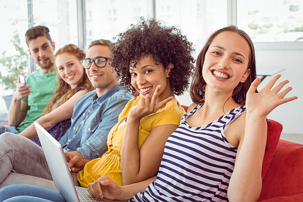 istock Fashion students smiling and waving to camera 472973730