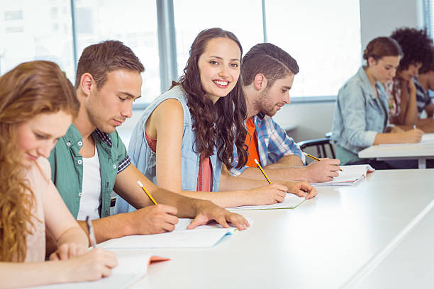 istock Fashion student smiling at camera in class 472973776