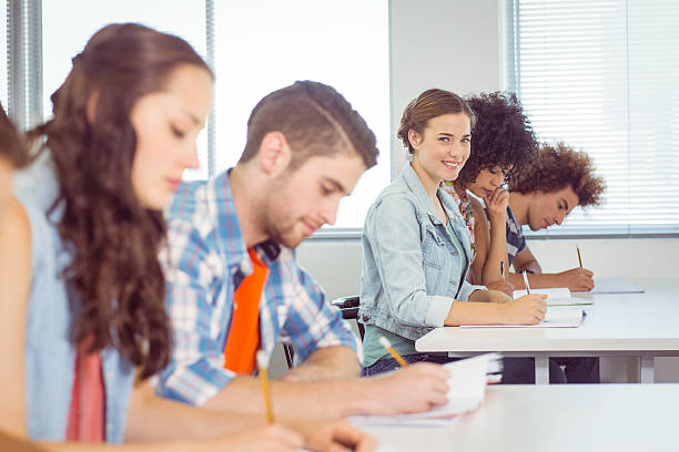 istock Fashion student smiling at camera in class 472973786
