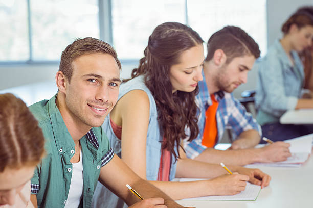 istock Fashion student smiling at camera in class 472973798