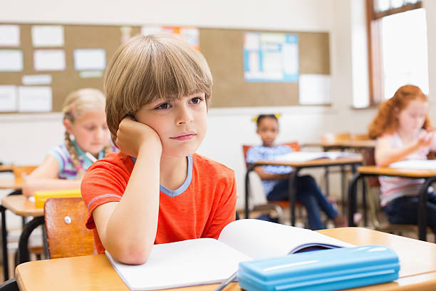 istock Concentrate pupils sitting at his desk 472974600