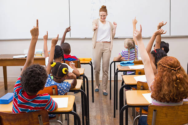 istock Teacher giving a mathematics lesson in classroom 472977002