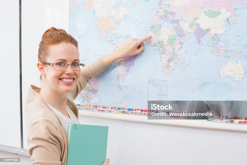 Teacher giving a geography lesson in classroom Teacher giving a geography lesson in classroom at the elementary school 20-24 Years Stock Photo