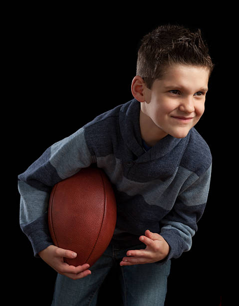 istock Young Boy Posing With Football 472980414