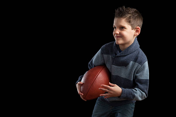 istock Boy Holding Football and Posing 472980664