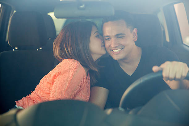 istock Cute girl kissing the driver 472984390