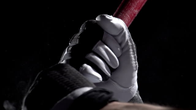 Close up of hands on a baseball bat, slow motion