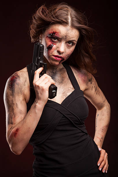 istock Beautiful sexy girl with gun. Posing in studio. 472986422
