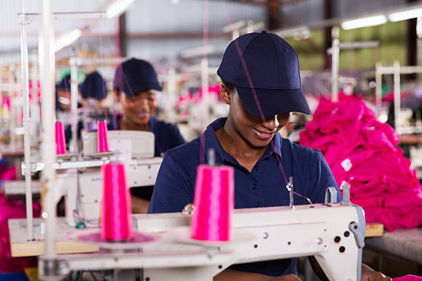 istock african worker sewing in clothing factory 472987232